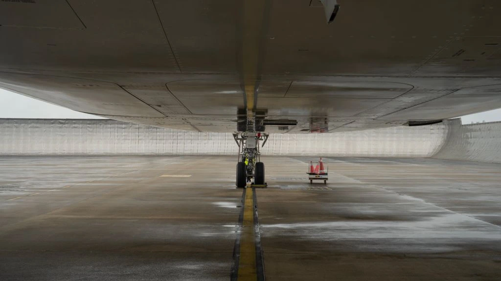 A commercial aircraft on a quiet tarmac at first light